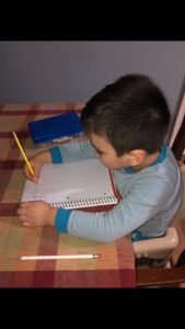 Student practicing writing at home.
