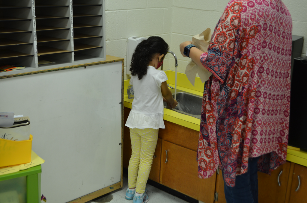 Student washing their hands.